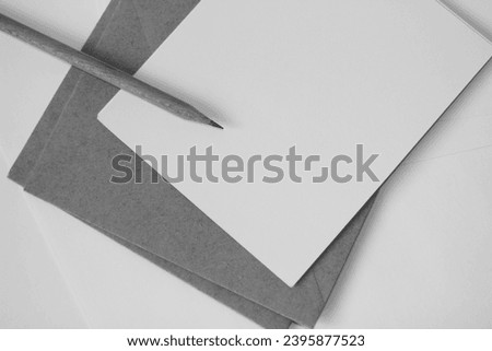 Blank Cards, Kraft Envelopes, Graphite Pencil on Office Desk, Top View. Black and White Business Mockup.