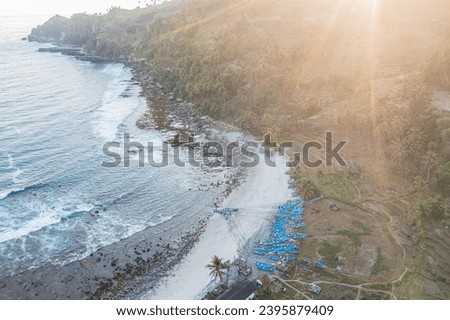 aerial view of the sea and rice fields with small fishing boats and decorated by the sunset