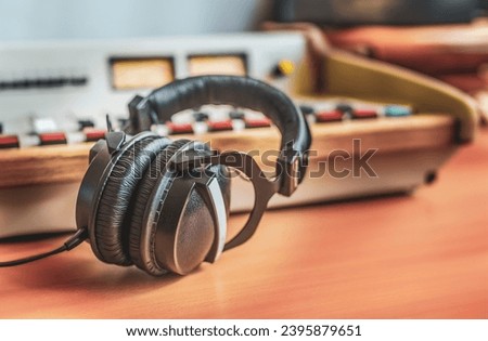 Headphones and sound mixer in radio studio