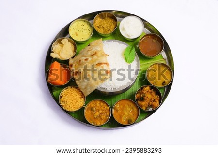 South Indian meals combination of sweet, salt, bitter, sour and spicy mixed with rice or chapathi as main dish. all the recipes or dishes served in the the thali makes a perfect balance and serves all Royalty-Free Stock Photo #2395883293