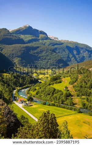 The Fortun Scenic Viewpoint along route 55 near Fortun, Vestland, Norway is a great spot to take a landscape image of the valley that is home to this scenic river village. Royalty-Free Stock Photo #2395887195