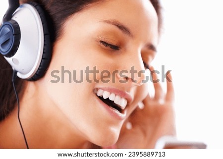 Music headphones, singing and woman face listening to playlist track, audio podcast or wellness sound. Freedom, eyes closed and closeup girl, student or singer streaming media, song or radio app