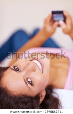 Portrait, smile and woman with phone on bed, social media and relax at home in the morning. Face, happy person on smartphone in bedroom and typing, scroll or communication on internet, mobile or app