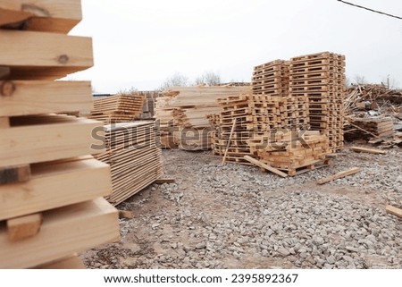 Large number of wooden pallets in production. Wooden pallets are in the racks.