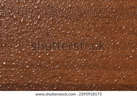 Top view of water drops on wooden background Royalty-Free Stock Photo #2395918173