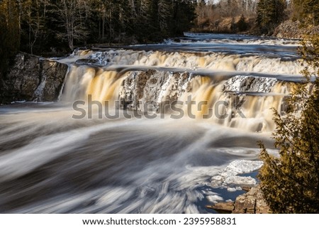 Long Exposure of Flowing Scenic Waterfall in Winter