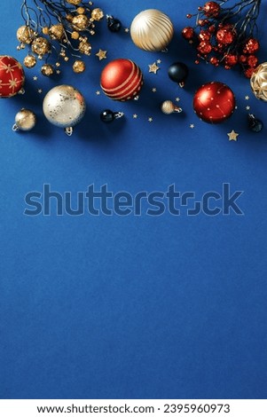 Christmas frame border of balls, branches of berries, decorations on dark blue background