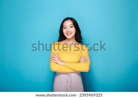 half body photo of nice positive lady crossed arms posing empty space ad isolated, Portrait of a friendly young woman smiling happily, Portrait of a beautiful young woman in a light blue background, 