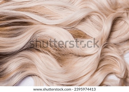 A hair texture of the beautiful, shiny and healthy locks light honey blond, dirty blond, ombre hair, isolated on white, horizontal ratio Royalty-Free Stock Photo #2395974413