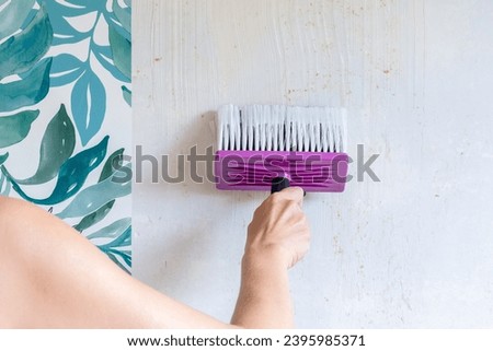 Installing wallpaper. Paste the wall. Royalty-Free Stock Photo #2395985371
