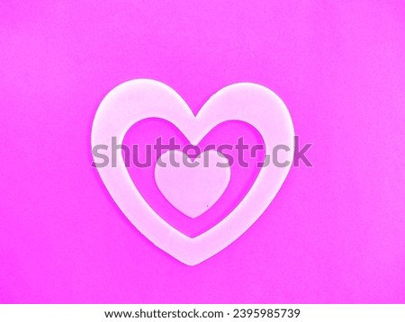 White hearts on pink background for Valentine's Day.