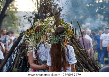 A wreath of wildflowers on the heads of girls during the summer Slavic holiday Ivan Kupala dedicated to the summer solstice. Russia Royalty-Free Stock Photo #2395989279
