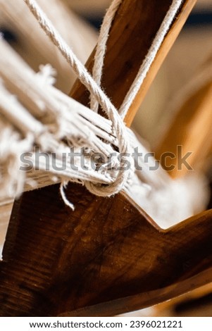 A close-up image of the warp and weft of a traditional Persian rug being woven in a workshop in Kashan. The image is a testament to the skill and artistry of the weavers, and it captures the beauty... Royalty-Free Stock Photo #2396021221