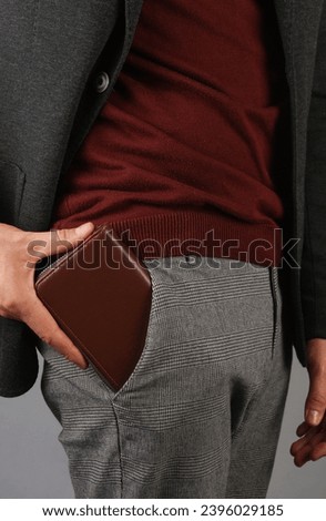 business man holding a wallet in his pocket Royalty-Free Stock Photo #2396029185