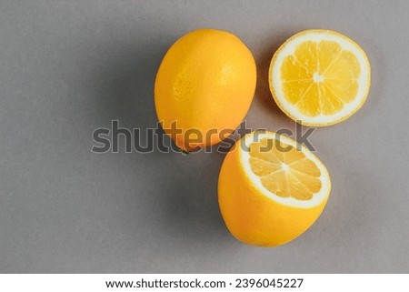 Fresh ripe lemons on gray background. Ultimate Gray and Illuminating colors of the year 2021. Color trend palette.