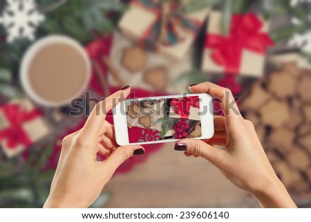 Hands taking picture of gingerbread cookies
