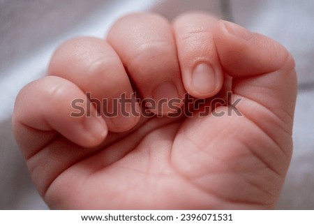 Macro shot of an infant's healthy hand while he is sleeping. Beautiful picture of a caucasian baby palm. Family and parenthood concept. 