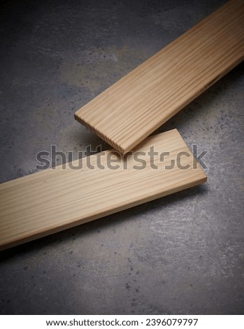 a long wooden prop on a rough-textured floor. An empty platform for display products, food and design Royalty-Free Stock Photo #2396079797