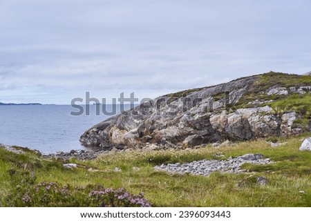 Wild but beautiful coast of Norwegian sea on the island Otroya in Norway close to city Midsund. Nice place with clean scandinavian nature without people, picture is taken in cloudy summer afternoon.