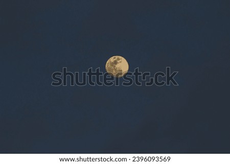 A captivating photograph of the full moon captured at night with a Canon EOS 600D camera, showcasing the ethereal beauty of the lunar landscape and the intricate details of its cratered surface. Royalty-Free Stock Photo #2396093569