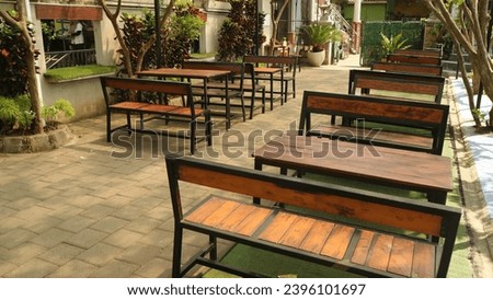 Wooden chair and table under the tree, outdoor cafe concept