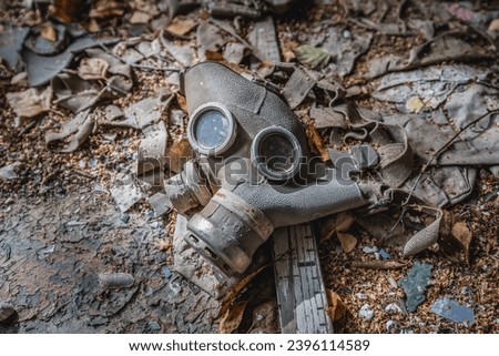 Gas mask in school in Illinci abandoned village in Chernobyl Exclusion Zone, Ukraine Royalty-Free Stock Photo #2396114589