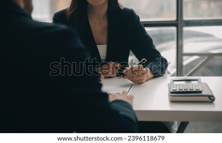 Businessman or job seeker review his resume on his desk before send to finding a new job with pen, necktie, glasses and digital tablet.
