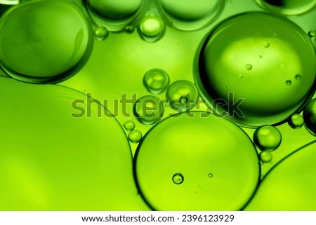 Green drops of oil or serum texture background. Abstract green fluid with bubbles. Macro shot
 Royalty-Free Stock Photo #2396123929
