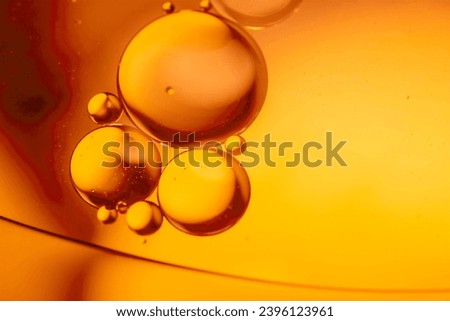 Gold drops of oil or serum texture background. Abstract yellow fluid with bubbles. Macro shot
 Royalty-Free Stock Photo #2396123961