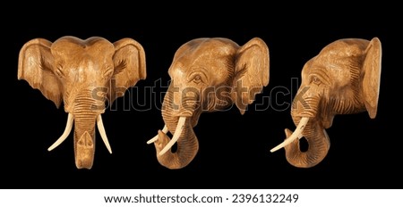 Sculpture (wood) picture elephant head. Isolated on pure black