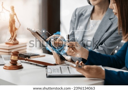 Teamwork female Legal counsel working with paperwork on his desk in office workplace working with tablet computer. Justice and law concept.