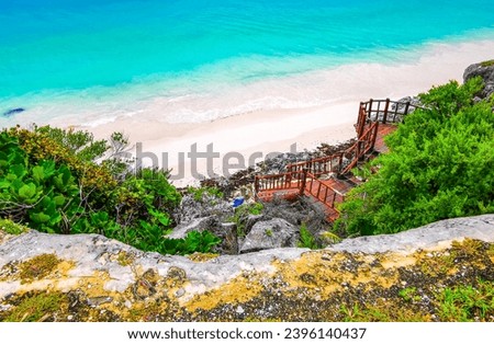Natural seascape and beach panorama view at the ancient Tulum ruins Mayan site with temple ruins pyramids and artifacts in the tropical natural jungle forest palm in Tulum Mexico. Royalty-Free Stock Photo #2396140437