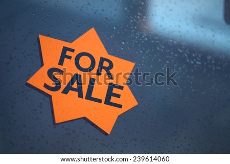 A "For Sale" sign displayed on a window.