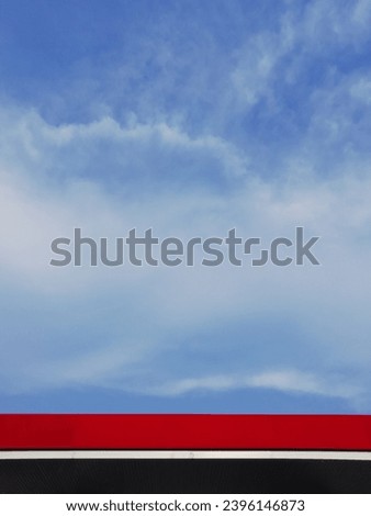 Red roof and cloudy blue sky