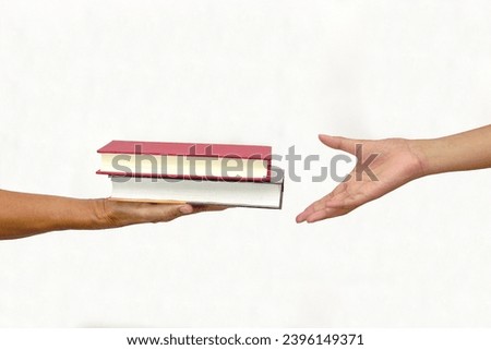 Two people exchanging books or sharing books on white background. exchanging knowledge and education concept. Royalty-Free Stock Photo #2396149371