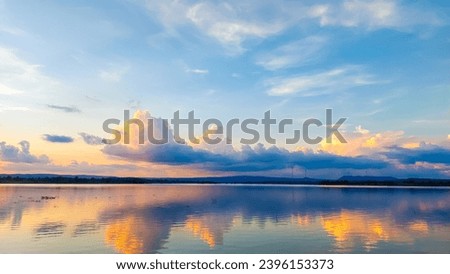 Sunset reflection and clouds in the reservoir