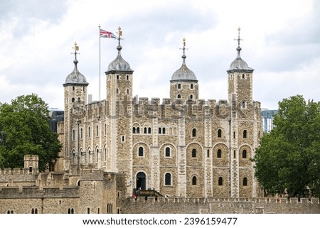 Close up of the Tower of London castle, home of the Crown Jewels, with the Union Jack flag raised - London, UK Royalty-Free Stock Photo #2396159477