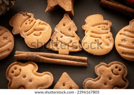 Christmas cookies, cinnamon sticks on dark background. Close-up. Christmas and New Year traditions concept