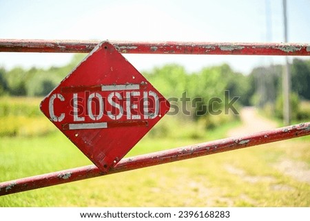 closed sign on old farm gate with defocused background