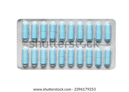 Metal tablet blister. Blue pills medicine. Silver shiny blister with drugs. Blue color capsules isolated on white. Cutout medicament isolated on white. Aluminum pills blister. Royalty-Free Stock Photo #2396179253