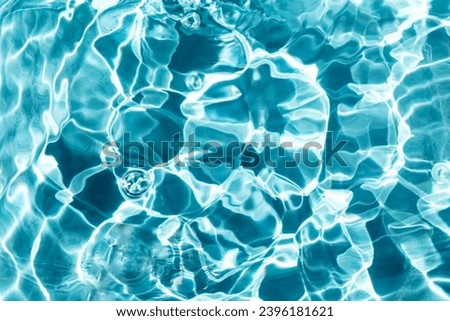 A storm in the water. Waves, ripples and bubbles. Pool, river, ocean. Blue textured background for your design. Selective focus, defocus