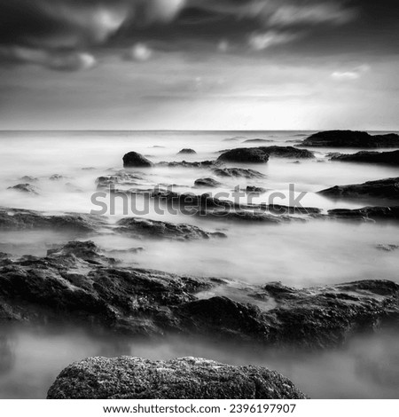 seascape rocky beach in black and white, A slow shutter speed was used to see the movement effect. 