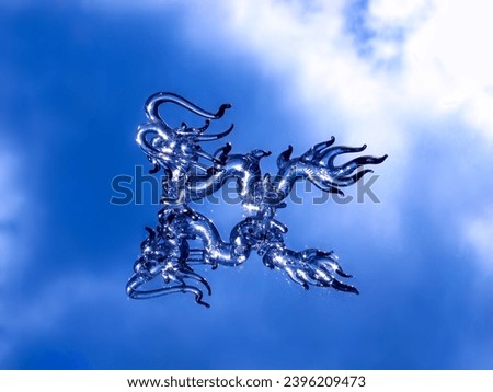 Glass Dragon on blue background. 2024 year of the dragon. Figurine of Chinese Dragon