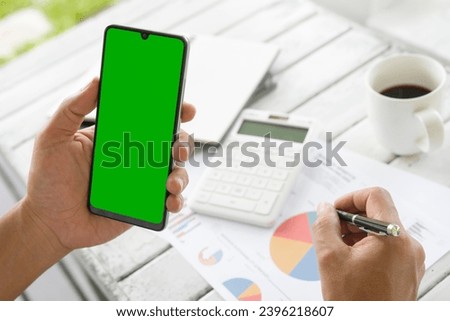 Businessmen use an empty smartphone to create opportunities for business growth. Business graphs, and charts on the coffee table. Financial development, Banking Account, Statistics