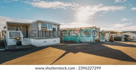 Mobile home park. A row of residential mobile park homes in a small town somewhere in California. Lifestyle, architecture, street view Royalty-Free Stock Photo #2396227299