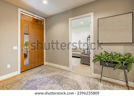 Interior foyer entry front door with hat rack coat hooks decor wood and tile flooring open door vaulted ceiling exposed brick wall welcome to a warm and comfortable family home Royalty-Free Stock Photo #2396235809