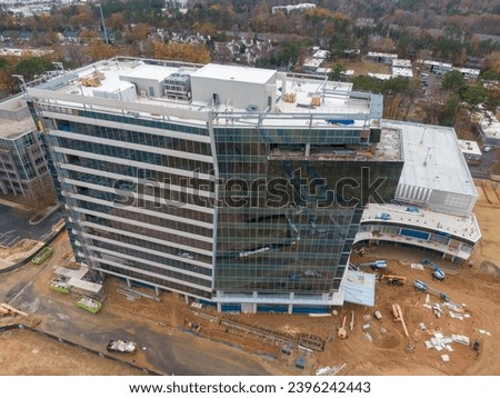 Various photos of buildings under construction outdoors in Raleigh North Carolina on an overcast day.