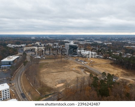 Various photos of buildings under construction outdoors in Raleigh North Carolina on an overcast day.