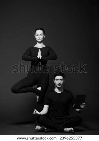 yoga man and yoga woman on a dark background black and white photo