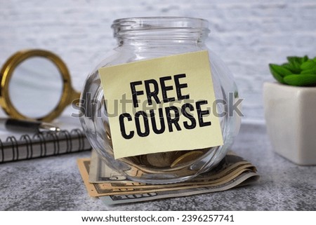 FREE COURSE. text on white paper. glasses and pencil.. Business concept Royalty-Free Stock Photo #2396257741